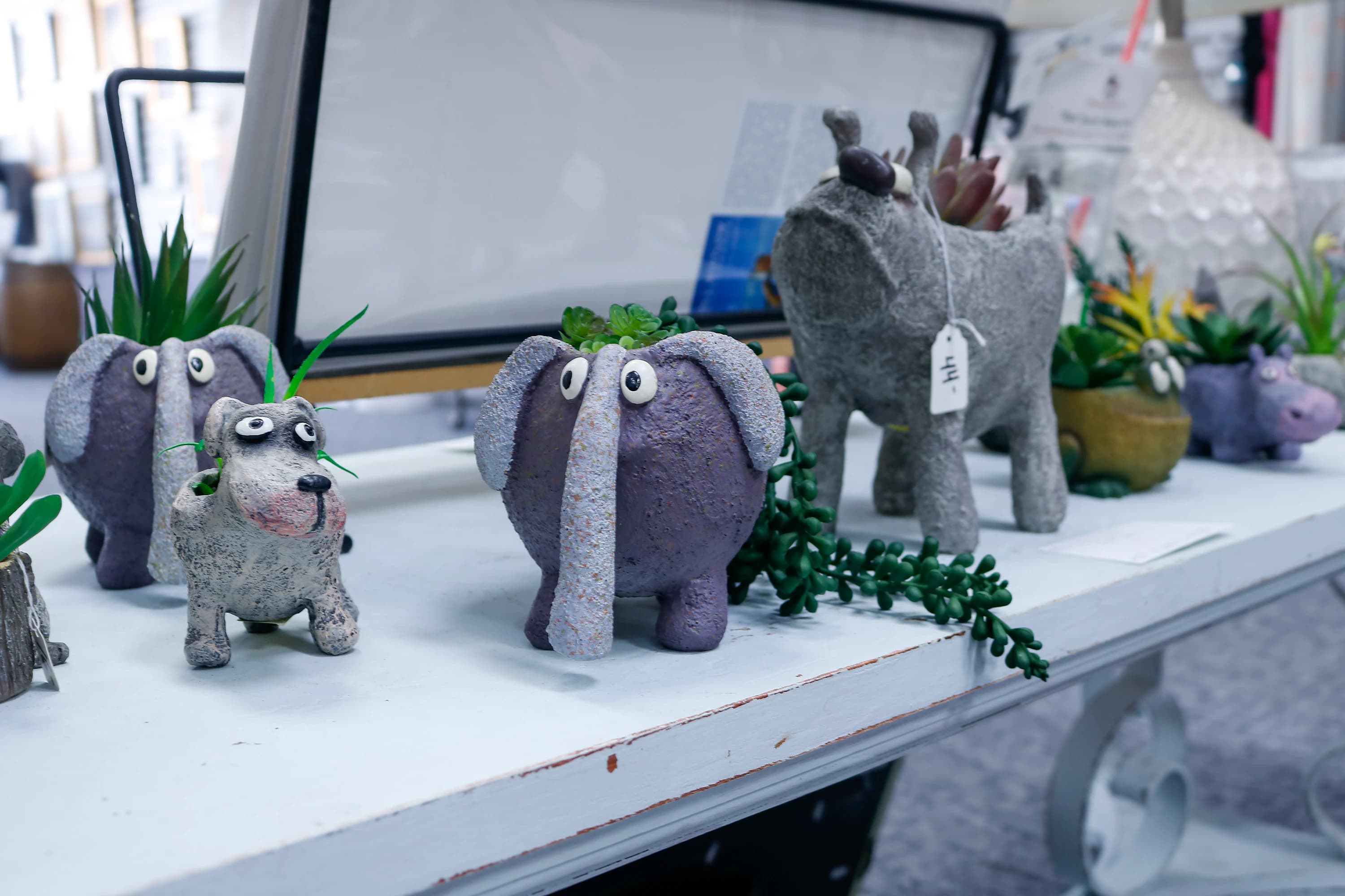 Whimsical cement elephant and dog planters with small succulents